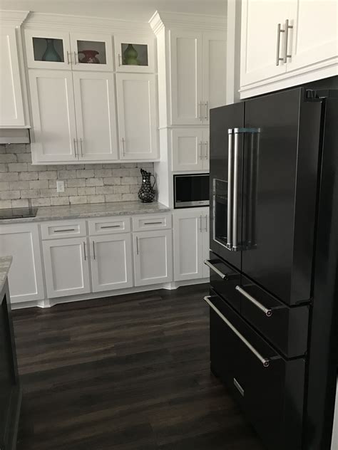 black stainless steel appliances white cabinets|black fridge in white kitchen.